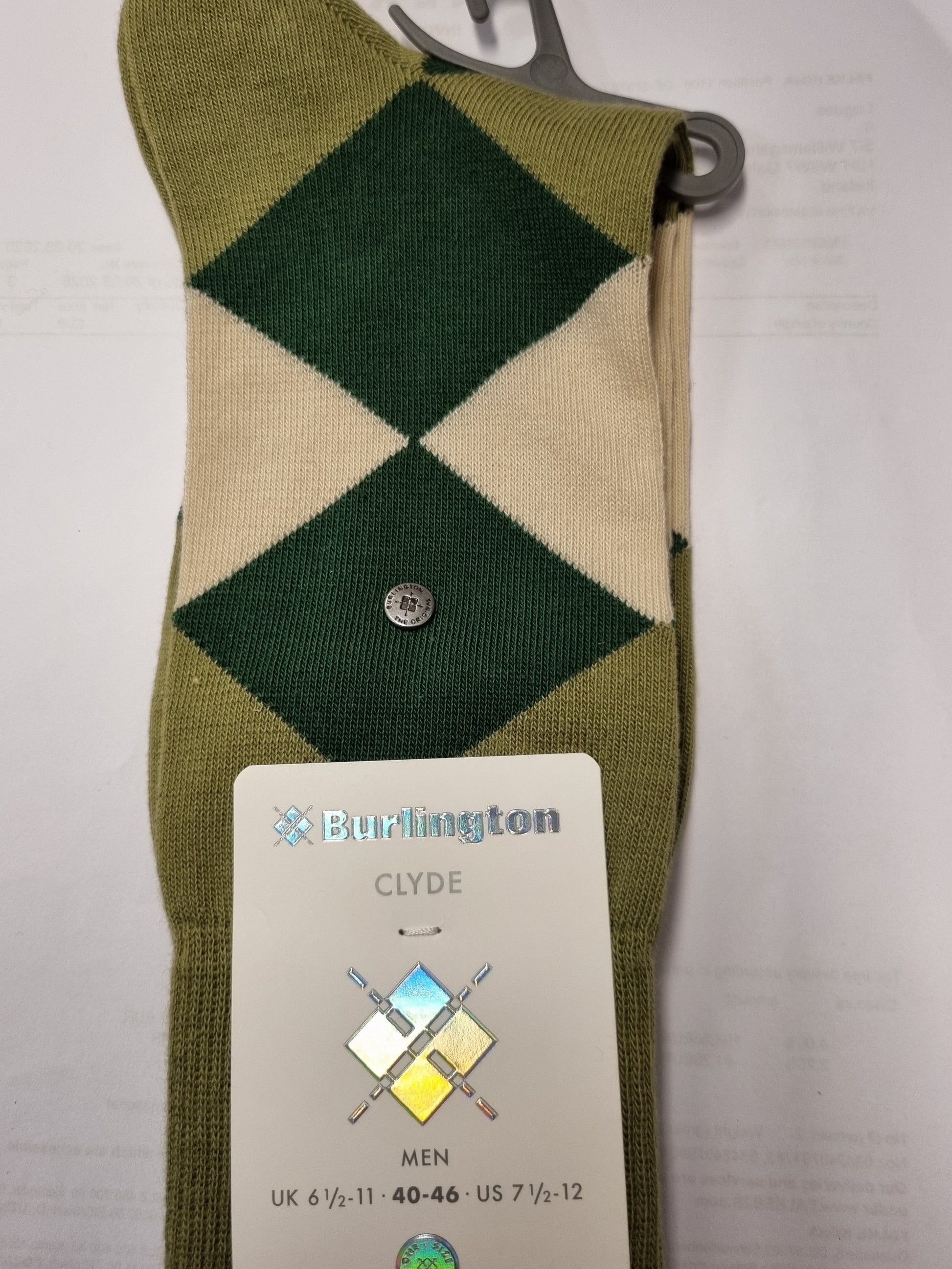 A single Arlington Clyde men's argyle sock in olive green and cream, shown with its paper hangtag and plastic hanger on a white background.