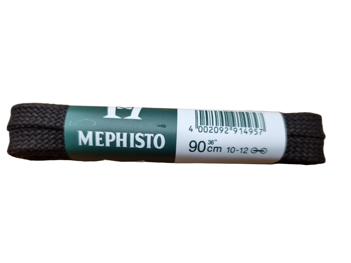 A pair of black shoelaces with a green and white paper label that reads 'MEPHISTO 90cm 10-12', placed on a wooden table.