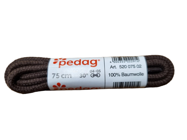 A pair of brown Pedag brand shoelaces with a white paper label, placed on a wooden surface.