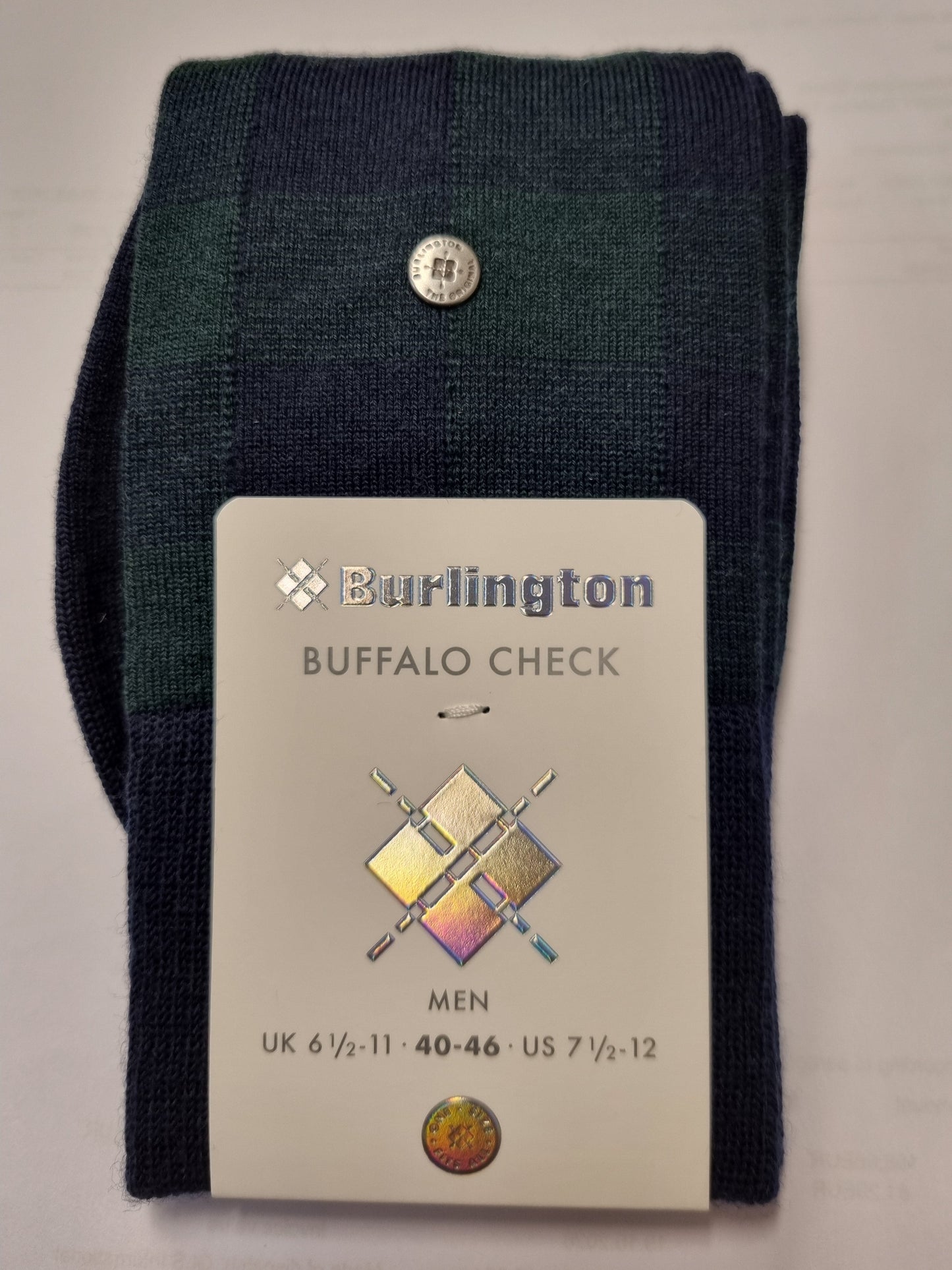 A folded pair of Burlington Buffalo Check men's knit socks in dark green and navy blue, with a white paper tag attached showing the brand and size information.